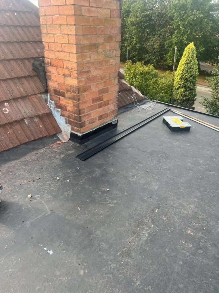 This is a photo of a flat roof which has just been repaired, there is also a chimney stack and some leadwork has also been dressed. Works carried out by LJ Roofing Faringdon